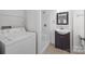Bright laundry room with washer, dryer, and shelving at 604 Beaten Path Rd, Mooresville, NC 28117