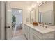 Bright bathroom boasting double vanity with quartz counters, gold fixtures, and access to the main bedroom at 625 Colorado Ave # B, Charlotte, NC 28206