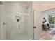 Elegant bathroom with a walk-in shower featuring marble-look tile and access to the primary bedroom at 625 Colorado Ave # B, Charlotte, NC 28206