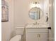 Bathroom featuring a toilet and vanity with white cabinets, gold hardware, and unique mirror at 625 Colorado Ave # B, Charlotte, NC 28206