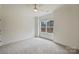Bright and airy bedroom with neutral carpeting and a large window providing natural light and neighborhood views at 625 Colorado Ave # B, Charlotte, NC 28206