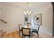 Cozy dining area featuring a round table, stylish chairs, and ample natural light from the backyard door at 625 Colorado Ave # B, Charlotte, NC 28206