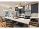Modern kitchen featuring navy cabinets, stainless steel appliances, and a quartz countertop island with seating at 625 Colorado Ave # B, Charlotte, NC 28206