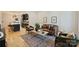 Open-concept living room showcasing a leather sofa, hardwood floors, and seamless flow into the modern kitchen at 625 Colorado Ave # B, Charlotte, NC 28206
