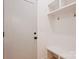 Mudroom with a bench and coat hooks and storage above, all painted white for a clean and bright space at 625 Colorado Ave # B, Charlotte, NC 28206
