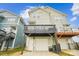 Back exterior view of the home featuring a deck and garage, set against a blue sky backdrop at 746 Waterscape Ct, Rock Hill, SC 29730