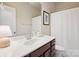Bathroom vanity features a white countertop, dark wood cabinets, and a large mirror at 746 Waterscape Ct, Rock Hill, SC 29730