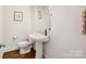 Powder room featuring a pedestal sink, modern fixtures, and stylish decor at 746 Waterscape Ct, Rock Hill, SC 29730