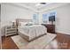 Bedroom features hardwood floors, windows, ceiling fan, and area rug at 746 Waterscape Ct, Rock Hill, SC 29730