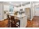 Modern kitchen with a granite island, stainless steel appliances, and hardwood floors at 746 Waterscape Ct, Rock Hill, SC 29730