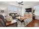 Cozy living room features hardwood floors, neutral decor, and a ceiling fan at 746 Waterscape Ct, Rock Hill, SC 29730