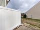 View of a white fence enclosing the backyard, offering privacy and security for outdoor enjoyment at 8272 Golf Ridge Dr, Charlotte, NC 28277