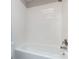 Bathroom featuring a white tiled tub with stainless steel fixtures at 8272 Golf Ridge Dr, Charlotte, NC 28277