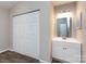 Bathroom featuring a white vanity and a double door closet at 8272 Golf Ridge Dr, Charlotte, NC 28277