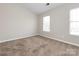 Well-lit bedroom featuring two windows, offering natural light and a comfortable atmosphere at 8272 Golf Ridge Dr, Charlotte, NC 28277