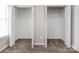 Spacious bedroom featuring two closets with white doors and metal shelves, providing ample storage at 8272 Golf Ridge Dr, Charlotte, NC 28277