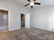 Bedroom with carpet, ceiling fan, and an attached bathroom and closet at 8272 Golf Ridge Dr, Charlotte, NC 28277