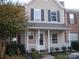 Inviting home featuring a cozy front porch and complementary landscaping at 8272 Golf Ridge Dr, Charlotte, NC 28277