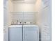 Laundry room with a stacked washer and dryer and a wire rack at 8272 Golf Ridge Dr, Charlotte, NC 28277