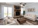 Bright living room with a stone fireplace as a central focal point at 8272 Golf Ridge Dr, Charlotte, NC 28277