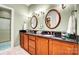 Elegant bathroom with double sinks, dark countertops, and modern fixtures at 8405 Olde Troon Dr # 4A, Charlotte, NC 28277