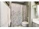 This bathroom has a shower/tub with a floral curtain and bright light, creating a relaxing space at 8405 Olde Troon Dr # 4A, Charlotte, NC 28277