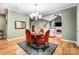 Open dining area with chandelier and view into an adjacent living space at 8405 Olde Troon Dr # 4A, Charlotte, NC 28277