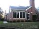 Beautiful brick home with a sunroom, lush greenery, and a well-maintained lawn at 8405 Olde Troon Dr # 4A, Charlotte, NC 28277