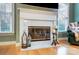 Close-up of marble fireplace with gas logs and decorative accents at 8405 Olde Troon Dr # 4A, Charlotte, NC 28277