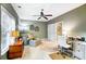 Well-lit home office features neutral walls, plush carpet, ceiling fan, and a comfortable seating area and work space at 8405 Olde Troon Dr # 4A, Charlotte, NC 28277