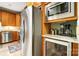 Kitchen area featuring stainless steel refrigerator, microwave, and built-in wine cooler at 8405 Olde Troon Dr # 4A, Charlotte, NC 28277