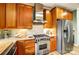 Beautiful kitchen featuring custom wood cabinets, granite countertops, and stainless steel appliances, including a gas range at 8405 Olde Troon Dr # 4A, Charlotte, NC 28277