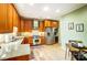 Bright kitchen featuring custom wood cabinets, stainless steel appliances, granite countertops, and a breakfast nook at 8405 Olde Troon Dr # 4A, Charlotte, NC 28277