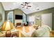 Bright living room with vaulted ceiling, fireplace, and large windows at 8405 Olde Troon Dr # 4A, Charlotte, NC 28277