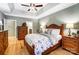 Spacious main bedroom with a tray ceiling, hardwood floors, and en-suite bathroom at 8405 Olde Troon Dr # 4A, Charlotte, NC 28277