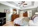 The main bedroom has a trey ceiling, ceiling fan, and a beautiful floral arrangement on the dresser at 8405 Olde Troon Dr # 4A, Charlotte, NC 28277