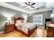 Comfortable main bedroom with hardwood floors, a ceiling fan, and ample natural light at 8405 Olde Troon Dr # 4A, Charlotte, NC 28277