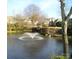Picturesque pond with a fountain and neighboring homes in the distance at 8405 Olde Troon Dr # 4A, Charlotte, NC 28277