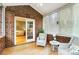 Charming sunroom with brick walls, light wood floor, and bright natural light at 8405 Olde Troon Dr # 4A, Charlotte, NC 28277