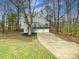 Gray two-story house with a three-car garage and deck at 8417 Raintree Ln, Charlotte, NC 28277