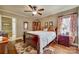 Comfortable main bedroom with a traditional bed frame, floral patterned rug, and warm natural lighting at 842 Mary Knoll Ct, Rock Hill, SC 29730