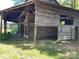 Distressed log barn exterior with wooden siding and open sides at 8725 Bringle Ferry Rd, Salisbury, NC 28146