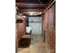 Unfinished basement bathroom with toilet and brick walls at 8725 Bringle Ferry Rd, Salisbury, NC 28146