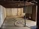 Unfinished basement with exposed pipes and concrete floor at 8725 Bringle Ferry Rd, Salisbury, NC 28146