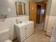 Updated bathroom with white vanity and tile flooring at 8725 Bringle Ferry Rd, Salisbury, NC 28146