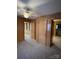 Spacious bedroom with wood paneling and ceiling fan at 8725 Bringle Ferry Rd, Salisbury, NC 28146