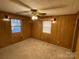 Bright bedroom with wood paneled walls and two windows at 8725 Bringle Ferry Rd, Salisbury, NC 28146