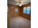 Bedroom with wood paneled walls, carpet and ceiling fan at 8725 Bringle Ferry Rd, Salisbury, NC 28146