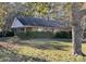 Brick ranch house with covered porch and mature trees in the yard at 8725 Bringle Ferry Rd, Salisbury, NC 28146