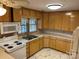 Bright kitchen features wood cabinets, tile flooring and an updated countertop at 8725 Bringle Ferry Rd, Salisbury, NC 28146